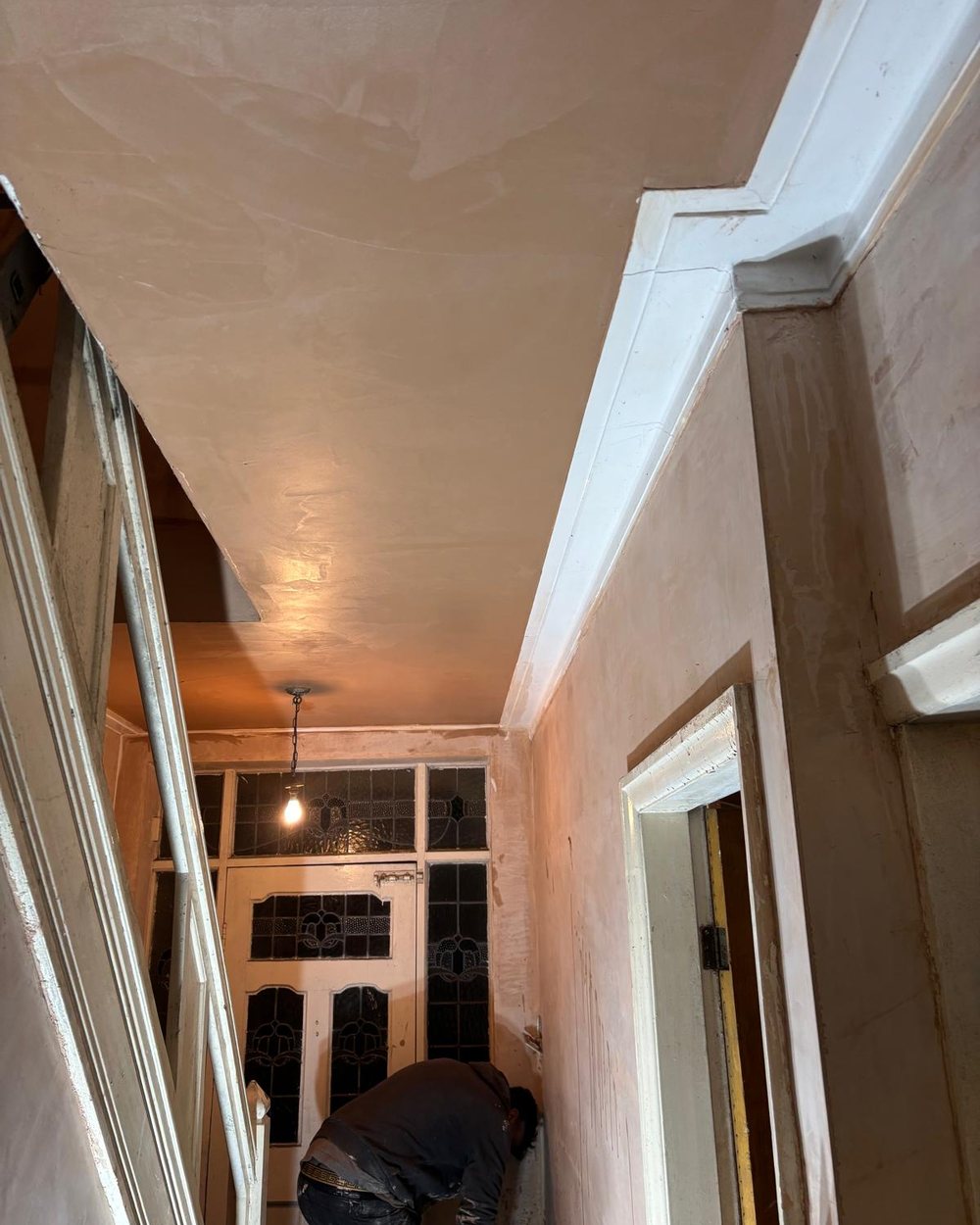 Freshly plastered hallway and ceiling by Barkerend Builders ready to decorate